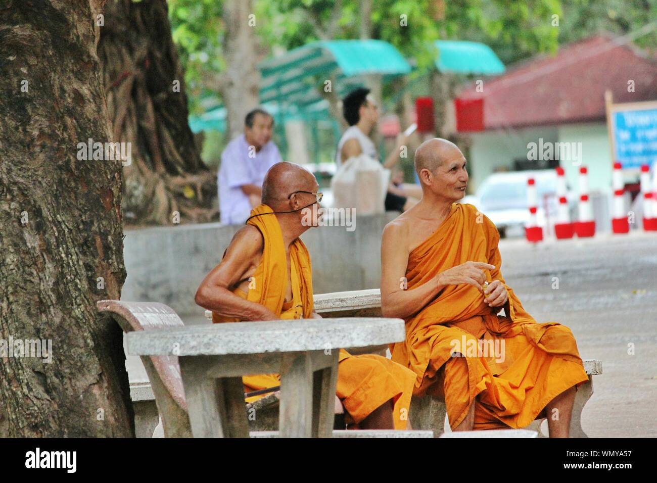 Monks Relaxing On Seat Stock Photo - Alamy