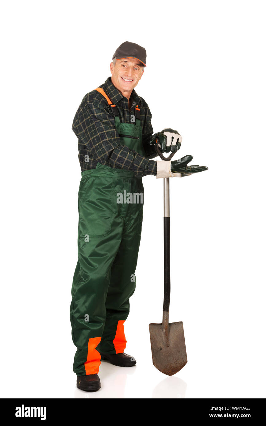 Full Length Portrait Of Gardener With Shovel Standing Against White