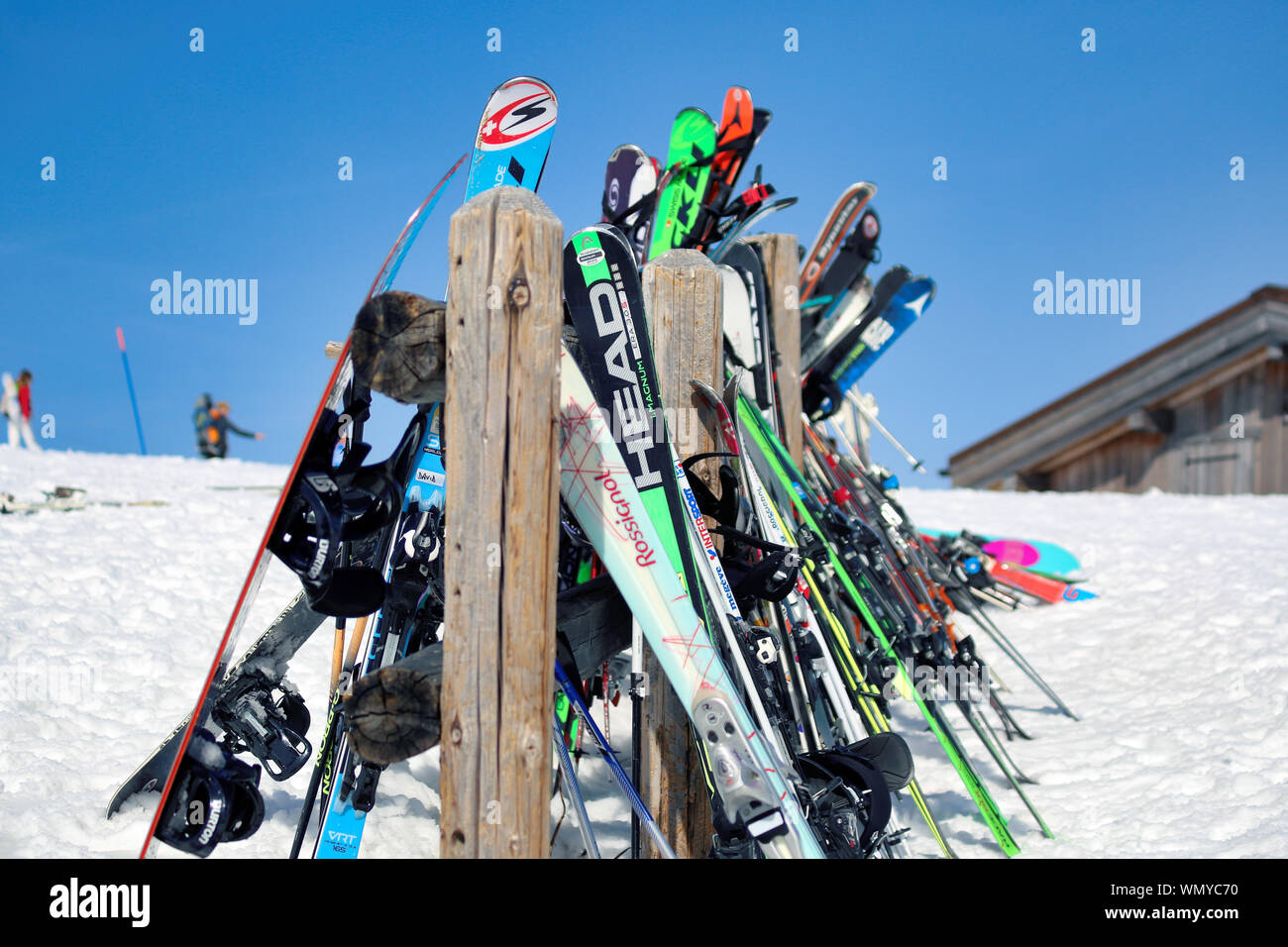 Skis, snowboards and ski sticks hanged to a ski & snowboard rack on a sunny day at Roche Fort -  Megeve of French Alps. Chamonix. Stock Photo