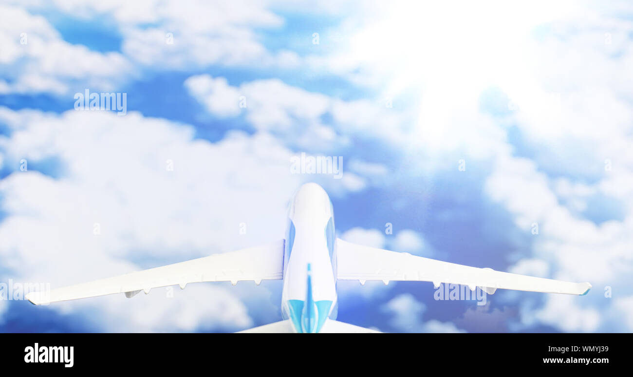 The plane flies in the sky above the clouds Stock Photo - Alamy