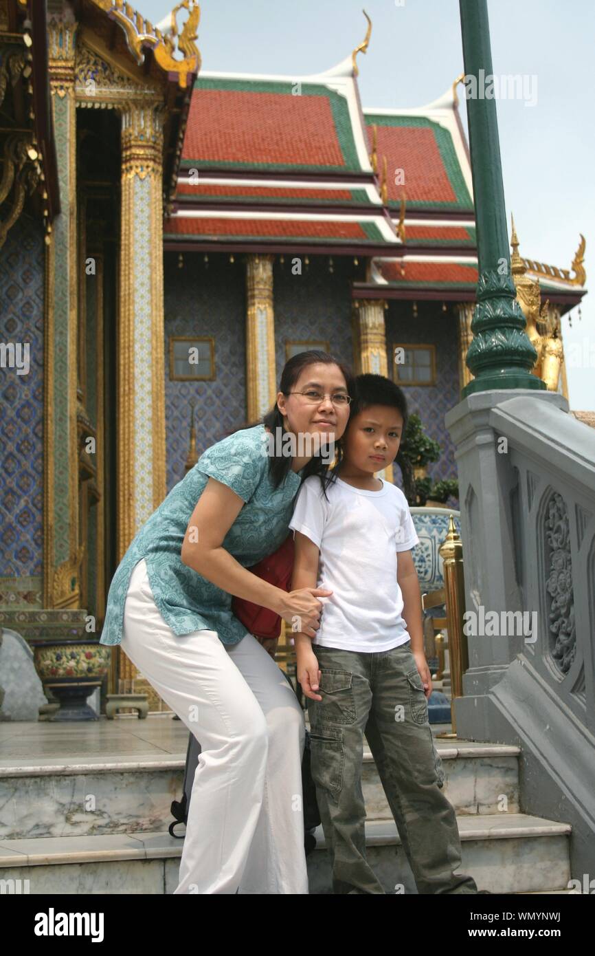Portrait Of Mother And Son Against Temple Stock Photo