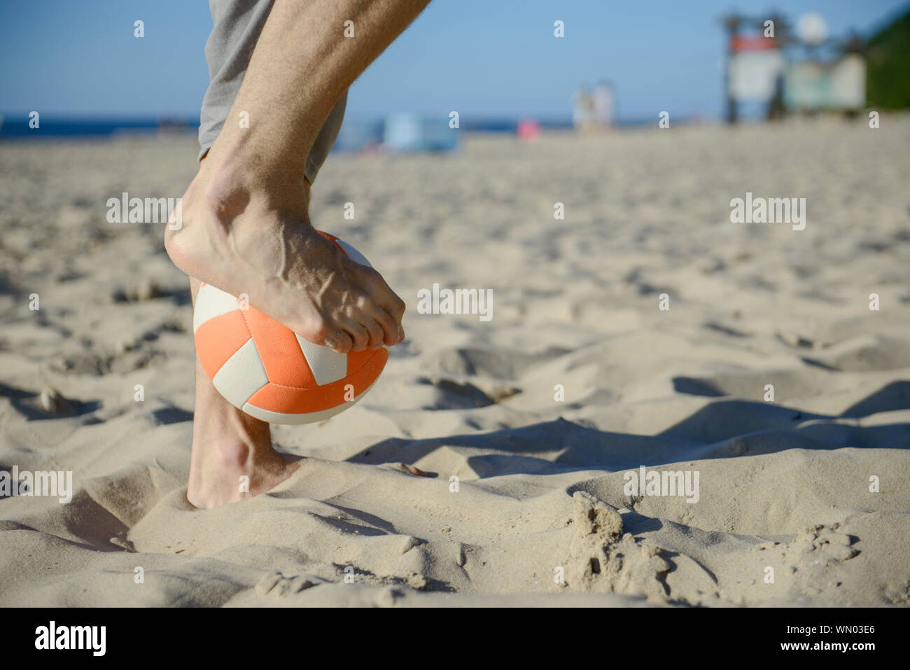 man playing soccer on beach with dribble skill and ball on vacation Stock Photo