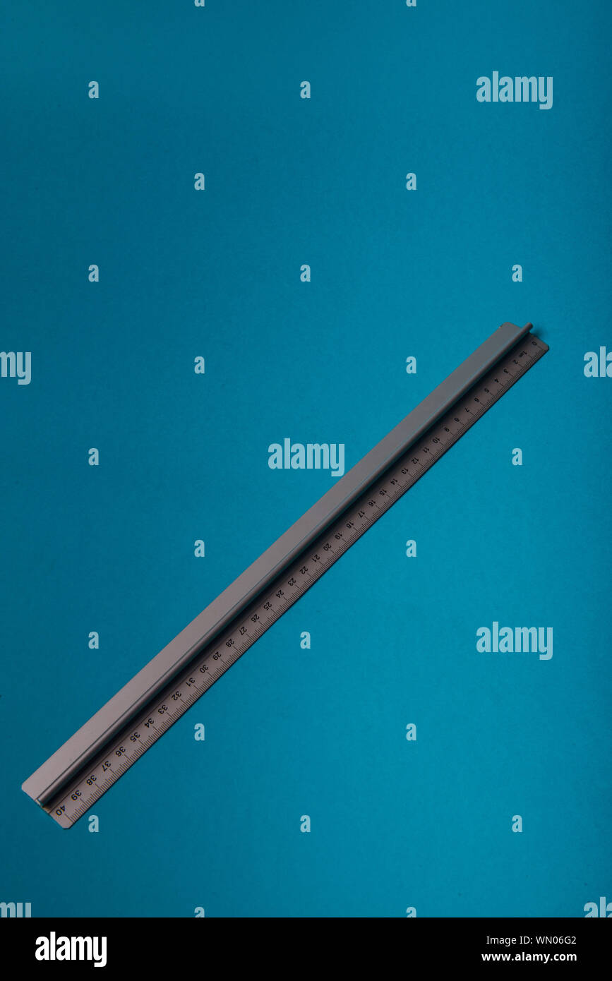 aluminum ruler on blue background. High resolution Stock Photo