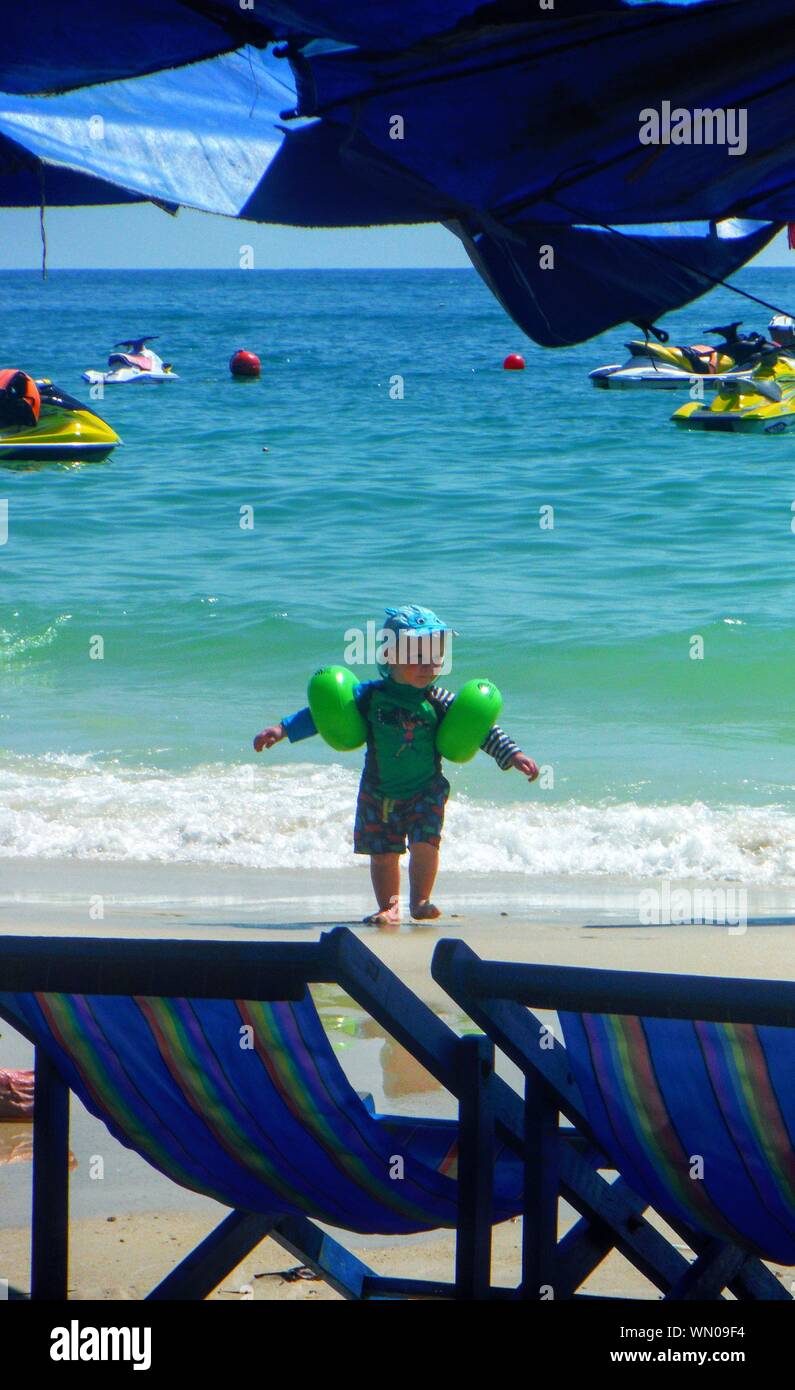 Child Wearing Water Wings On Seashore Stock Photo Alamy