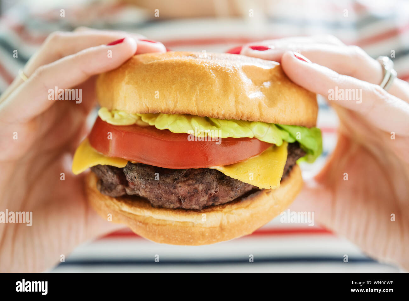 Woman holding hamburger Stock Photo