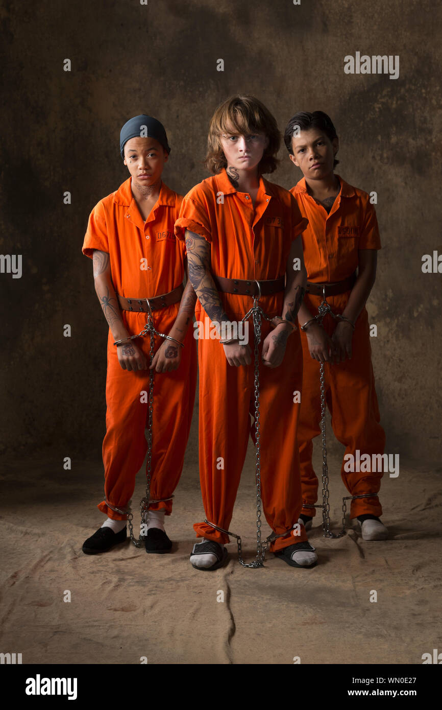 Boys in prisoner jumpsuits and handcuffs Stock Photo