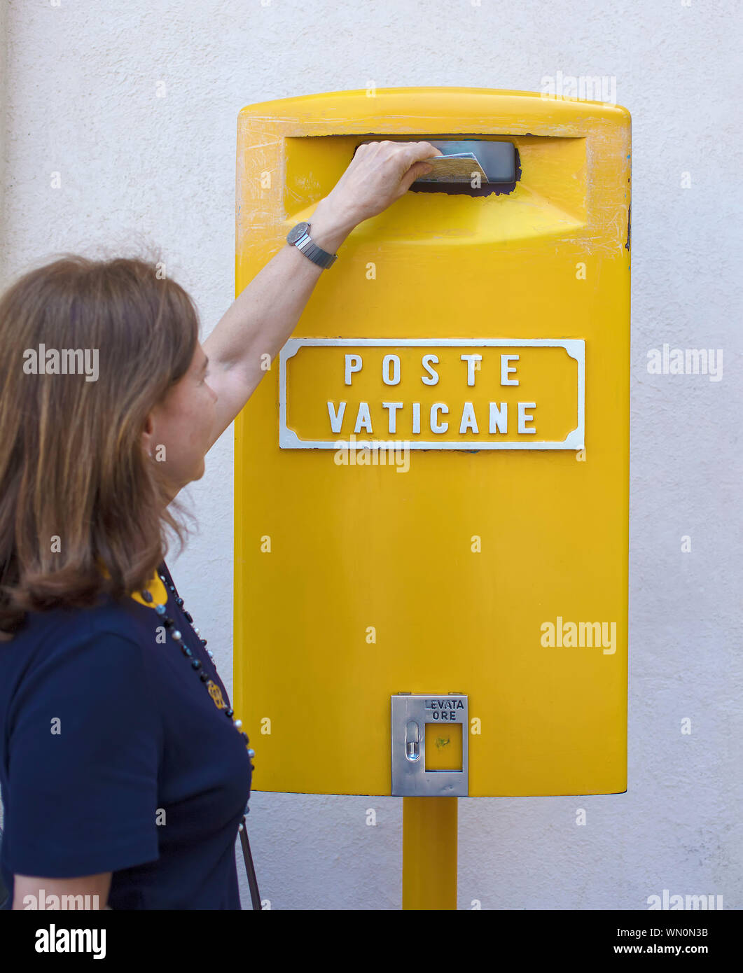 mailing a letter in a Vatican postbox Stock Photo