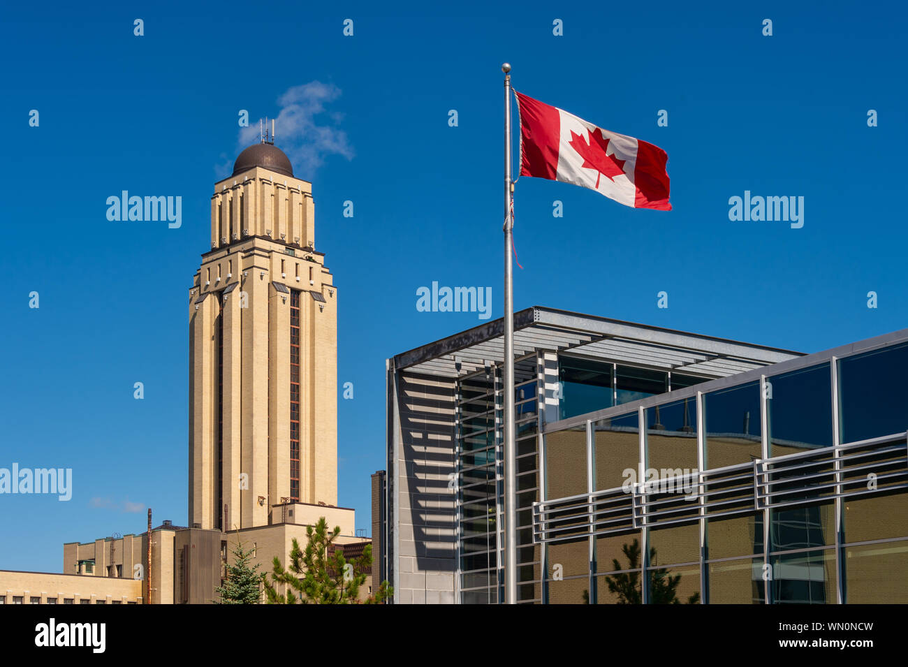 Montreal, CA - 5 September 2019: University of Montreal (UDEM) Pavilion Roger-Gaudry building & Canadian Flag Stock Photo