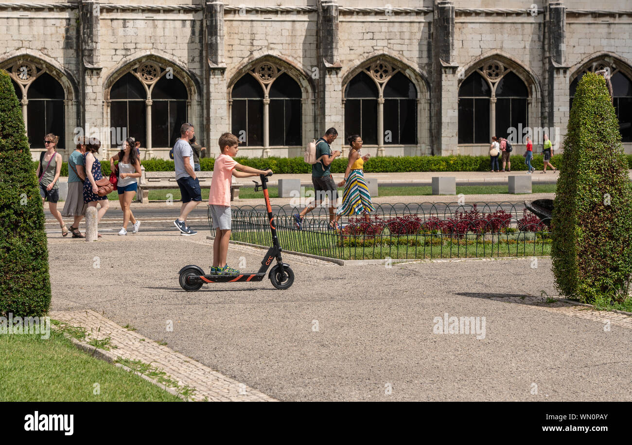 Boy riding Circ scooter by Jeronimos Monastery in Belem near Lisbon, Portugal Stock Photo