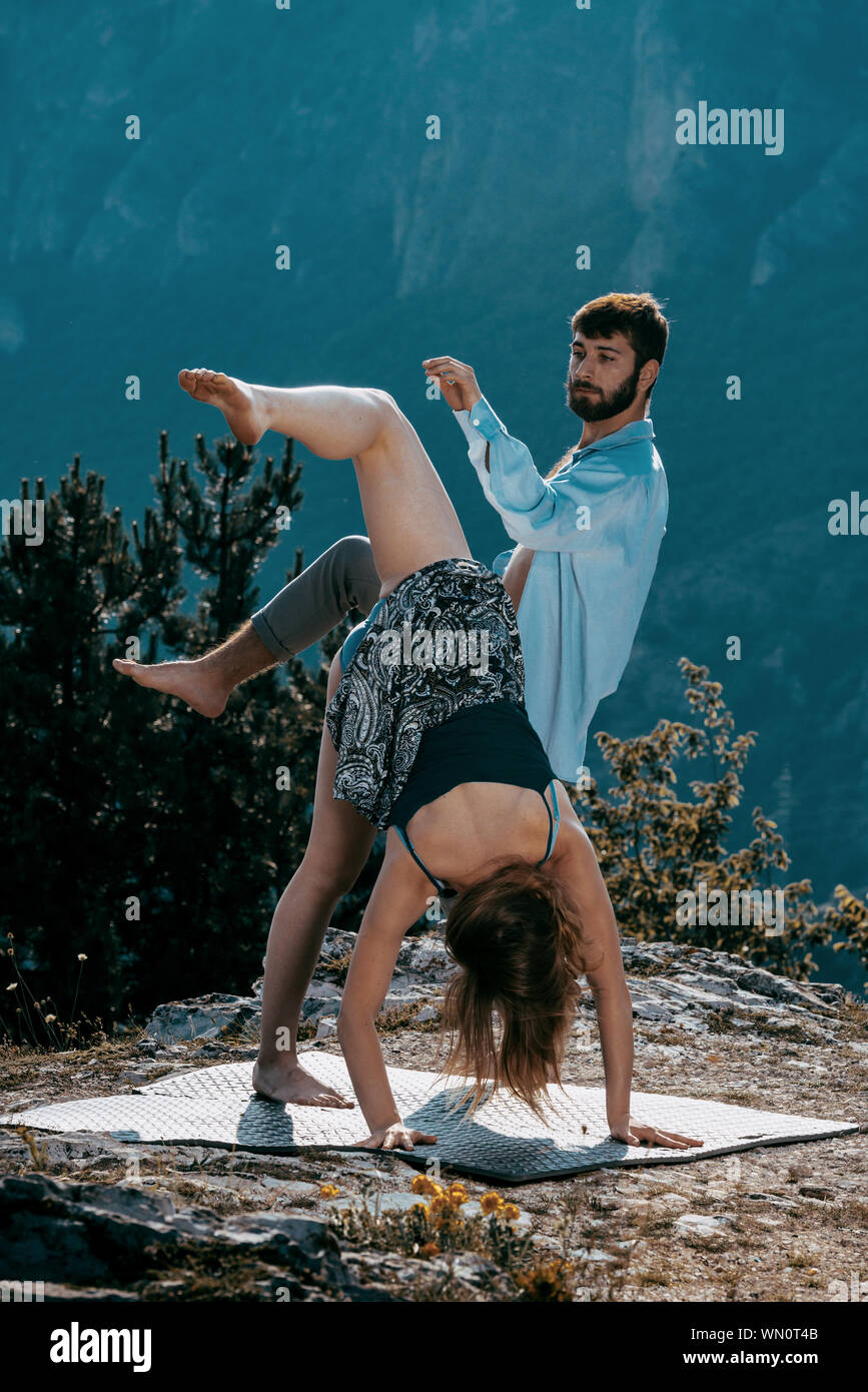 Two athletic young dancers making a performance at mountain peak Stock Photo
