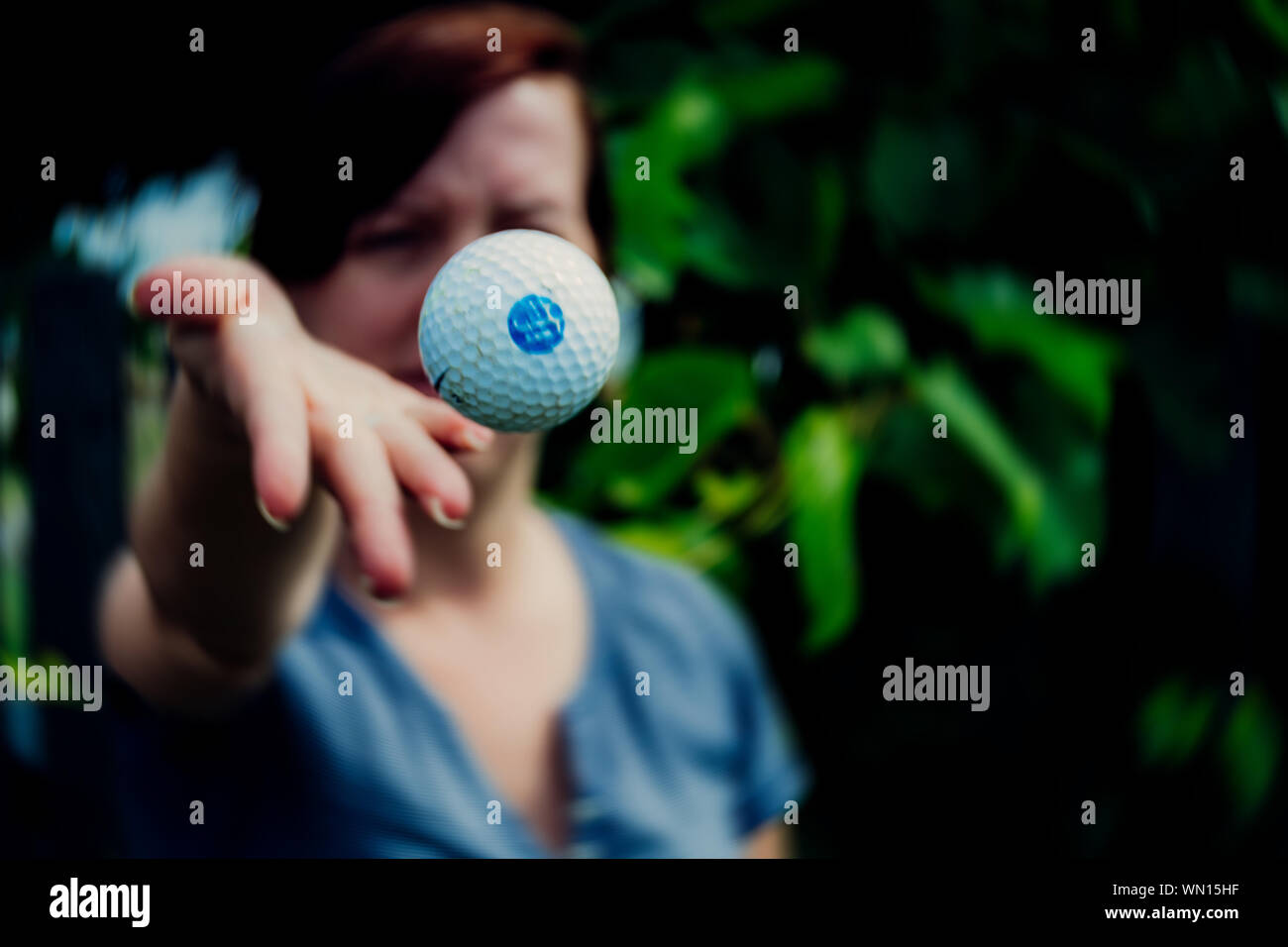 Woman Throwing Golf Ball In Back Yard Stock Photo Alamy