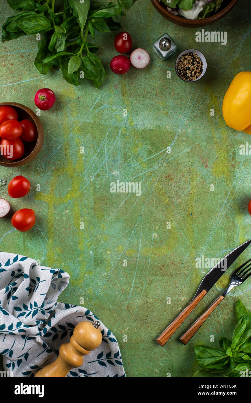 Tomatoes and basil on green surface Stock Photo - Alamy