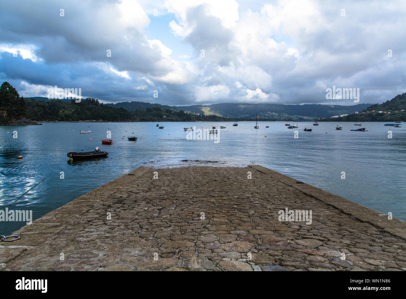 Boat Ramp On Sea Against Cloudy Sky Stock Photo