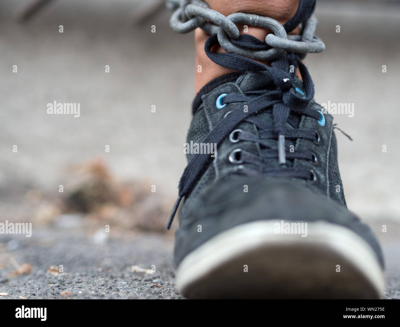 Low Section Of Man In Black Shoe And Chain Stock Photo