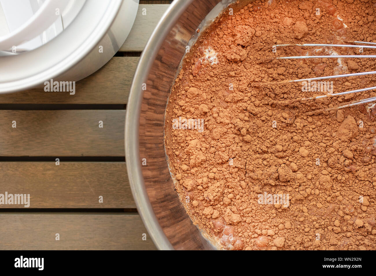 Chocolate icee cream mixture in a kitchen bowl with beater and ice cream maker Stock Photo