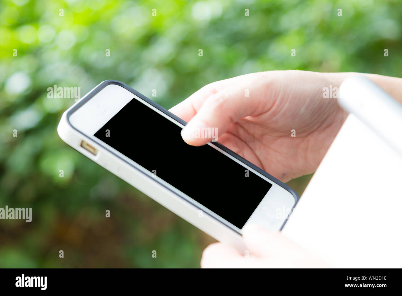 Hand of women using mobile smart phone with blank white screen green ...