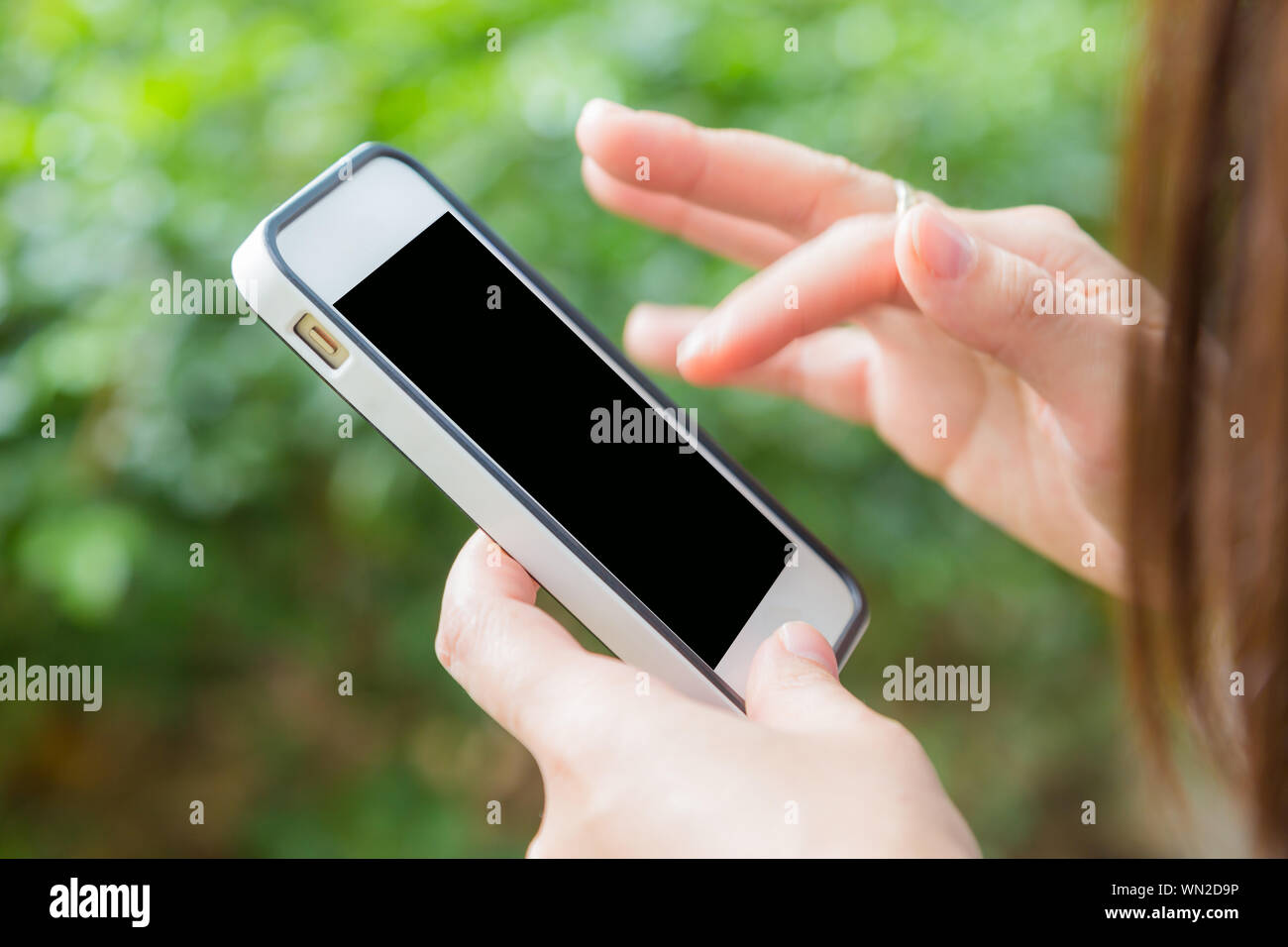 Hand of women using mobile smart phone with blank white screen green ...