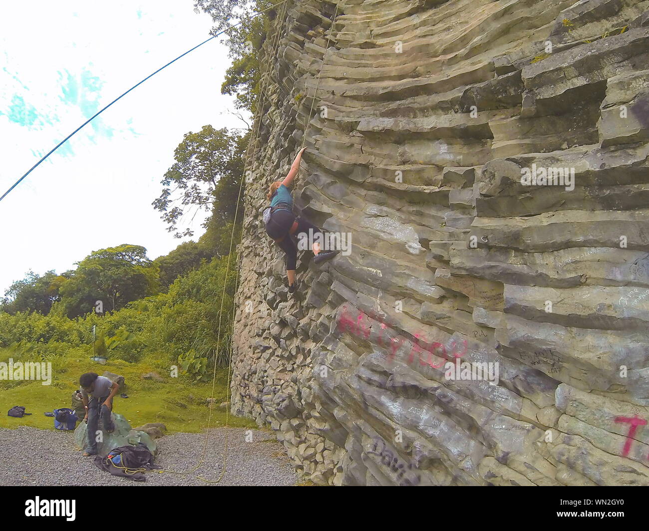 Climbing basalt rock in Boquete, Panama. Smooth and slippery top-roping only whilst on holiday in central America. Stock Photo