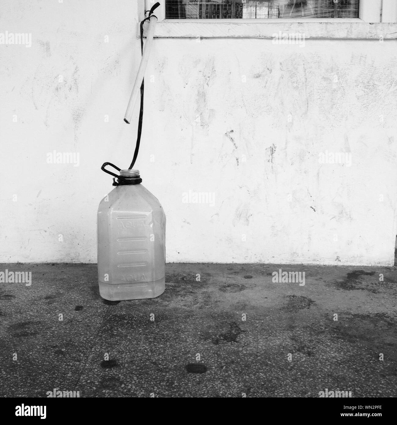 Water Dripping In Plastic Container Outside House Stock Photo Alamy