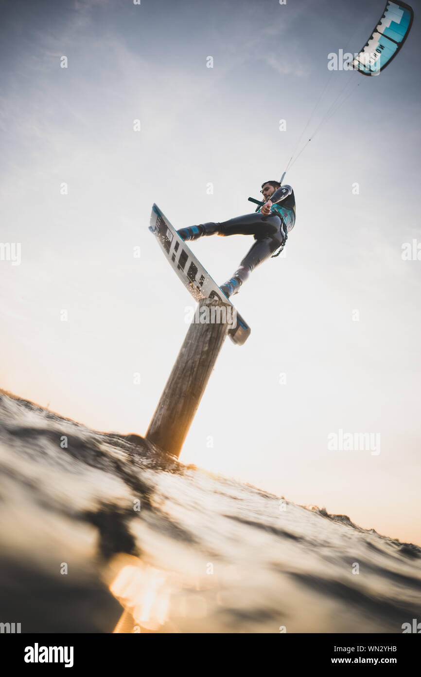Low Angle View Of Man Kiteboarding Against Sky Stock Photo