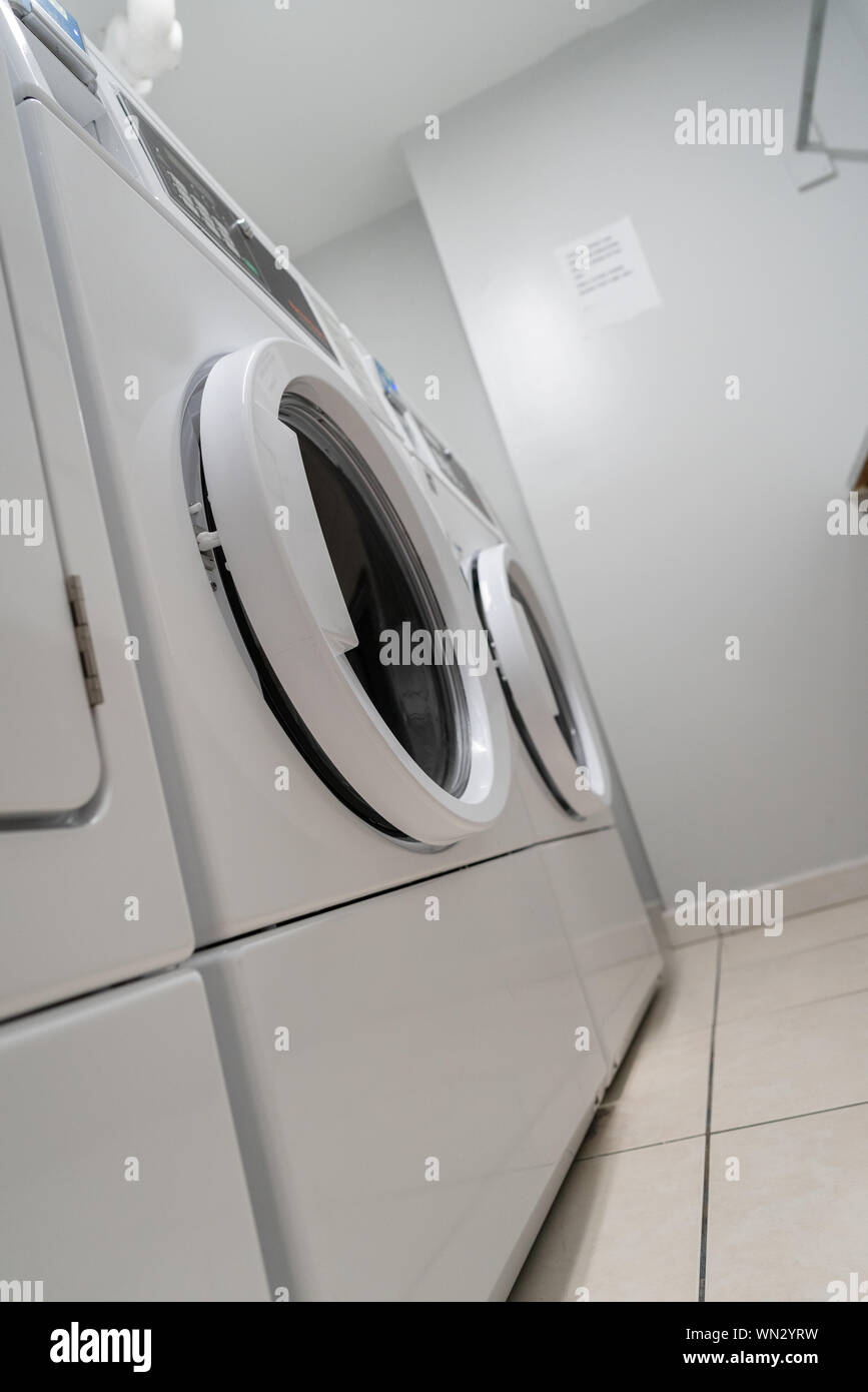 Commercial Laundry Equipment - Washers & Dryers. Stock Photo