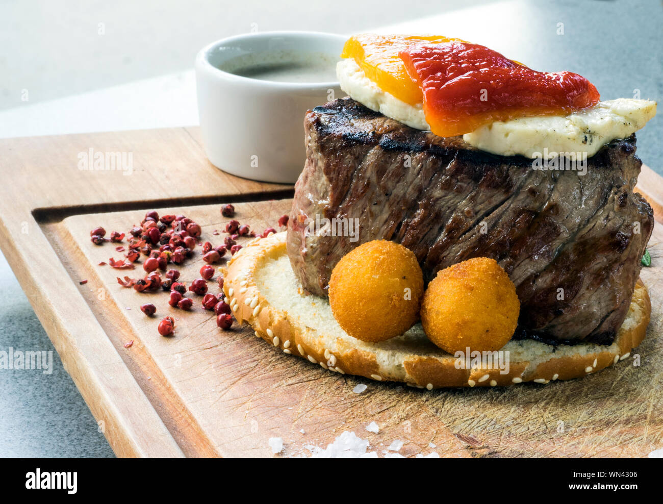 Close-up Of Fresh Filet Mignon Steak With Brynza And Mushroom Sauce On Wooden Cutting Board Stock Photo