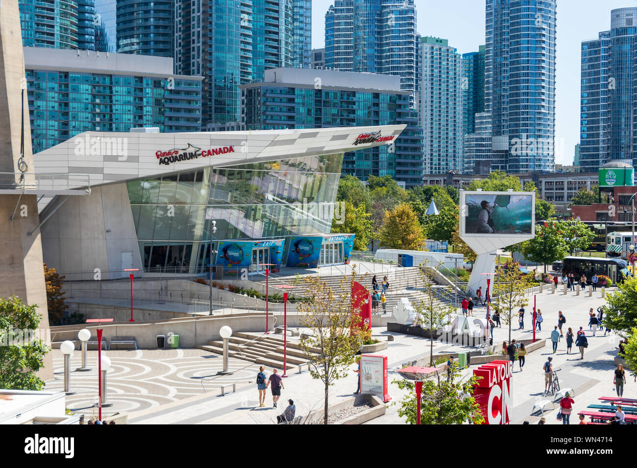 Outside of Ripley's Aquarium of Canada below the CN Tower on a busy, sunny day. Stock Photo