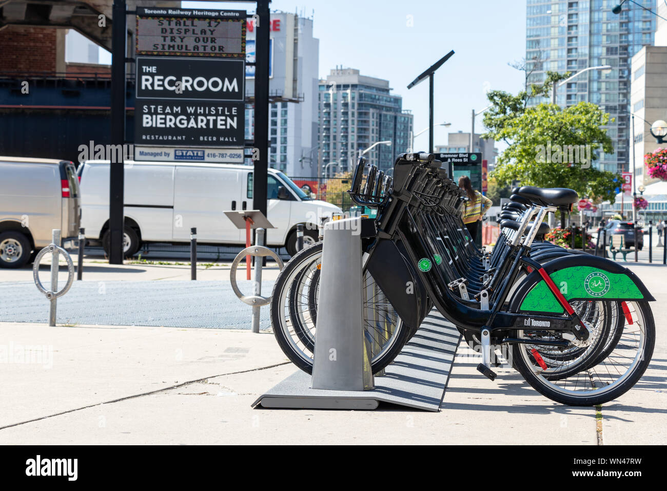Bike Share - Toronto rack in-front of Roundhouse Park in downtown Toronto on sunny day. Stock Photo