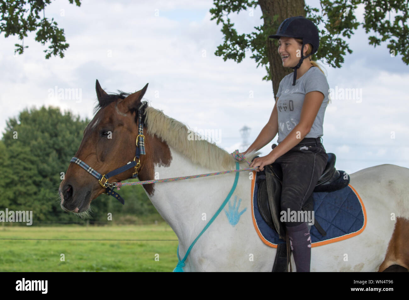Happy Teenager Riding Horse Stock Photo