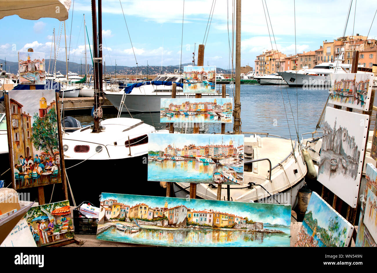 Artist and paintings abound on the foreshore in St Tropez, France Stock Photo