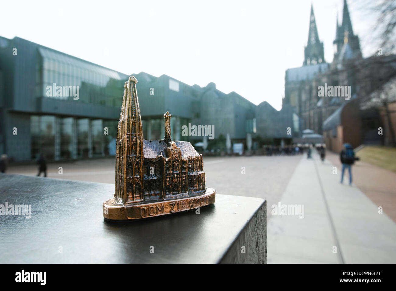 Close-up Of Cologne Cathedral Model On Retaining Wall With Museum In Background Stock Photo