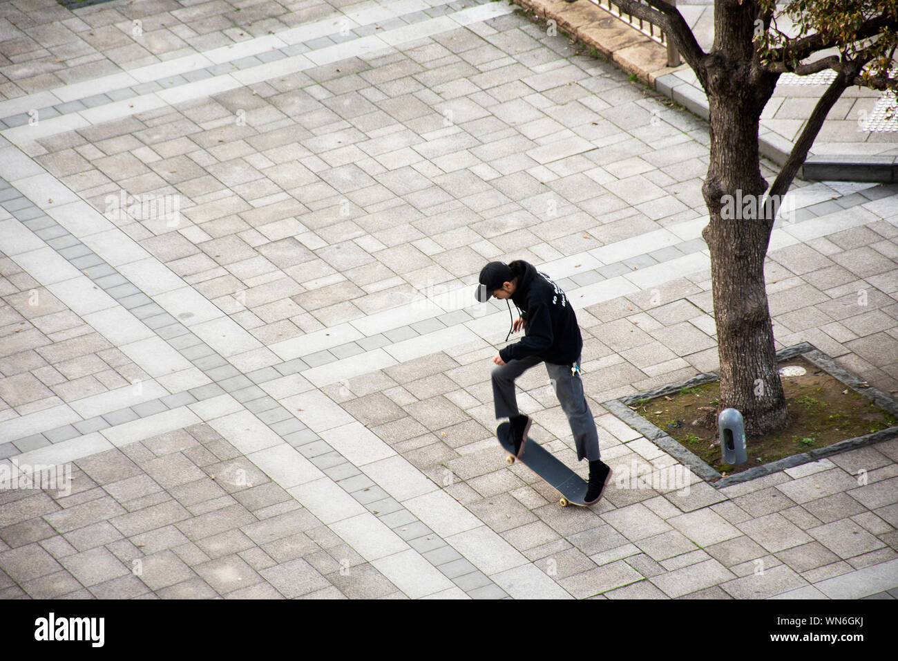 Japanese boy people play and riding skateboard in garden in Ariake town at Koto city on March 25, 2019 in Tokyo, Japan Stock Photo