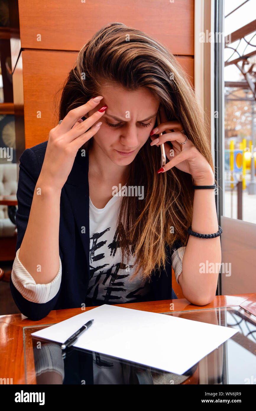 Young Woman Working In Cafe Stock Photo