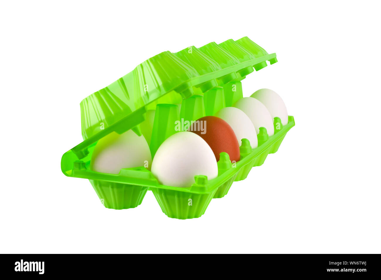 Dozen eggs white and one brown or red in open green plastic package on