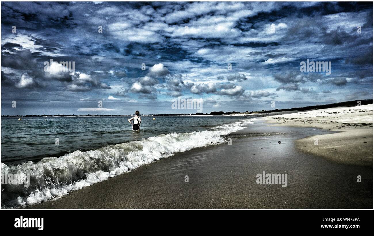 Women Standing Alone In The Water Stock Photo