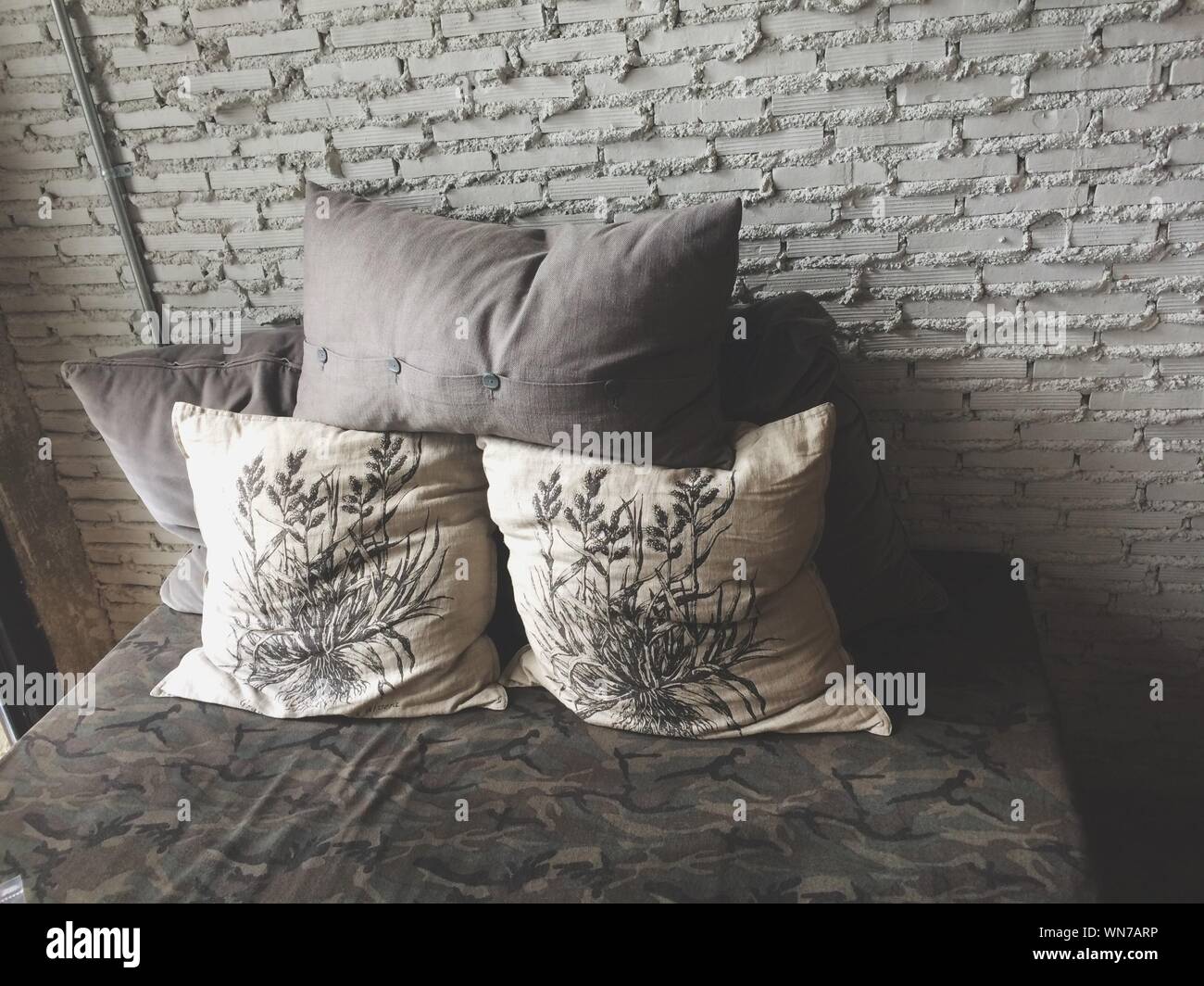 Cushions On Bed Against Wall In Bedroom At Home Stock Photo Alamy