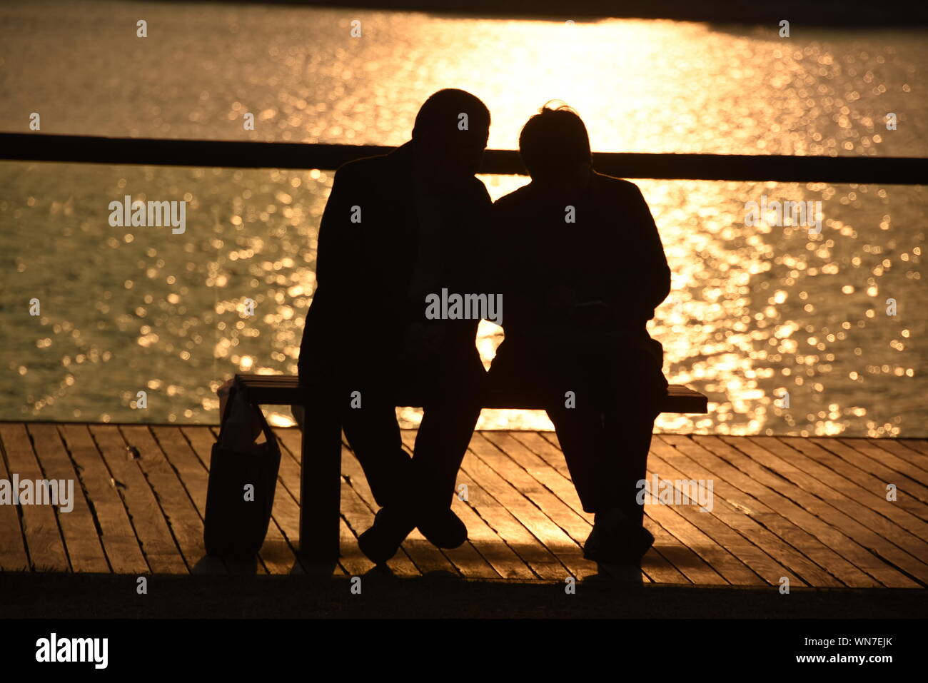 Silhouette Couple Sitting Bench Sunset Bench High Resolution Stock ...