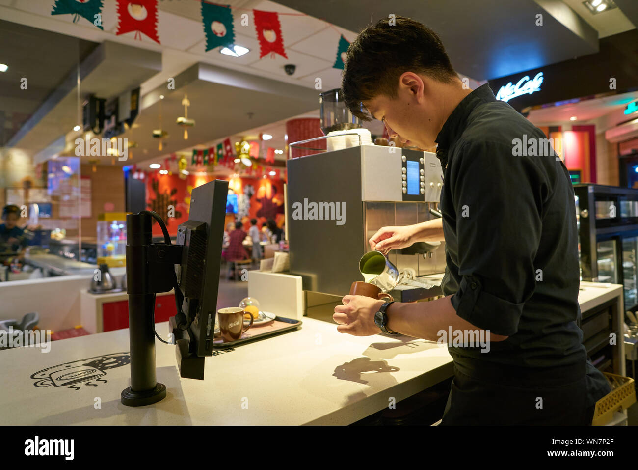 Mccafe Worker SHENZHEN, CHINA - CIRCA FEBRUARY, 2019: worker at McCafe in Shenzhen ...