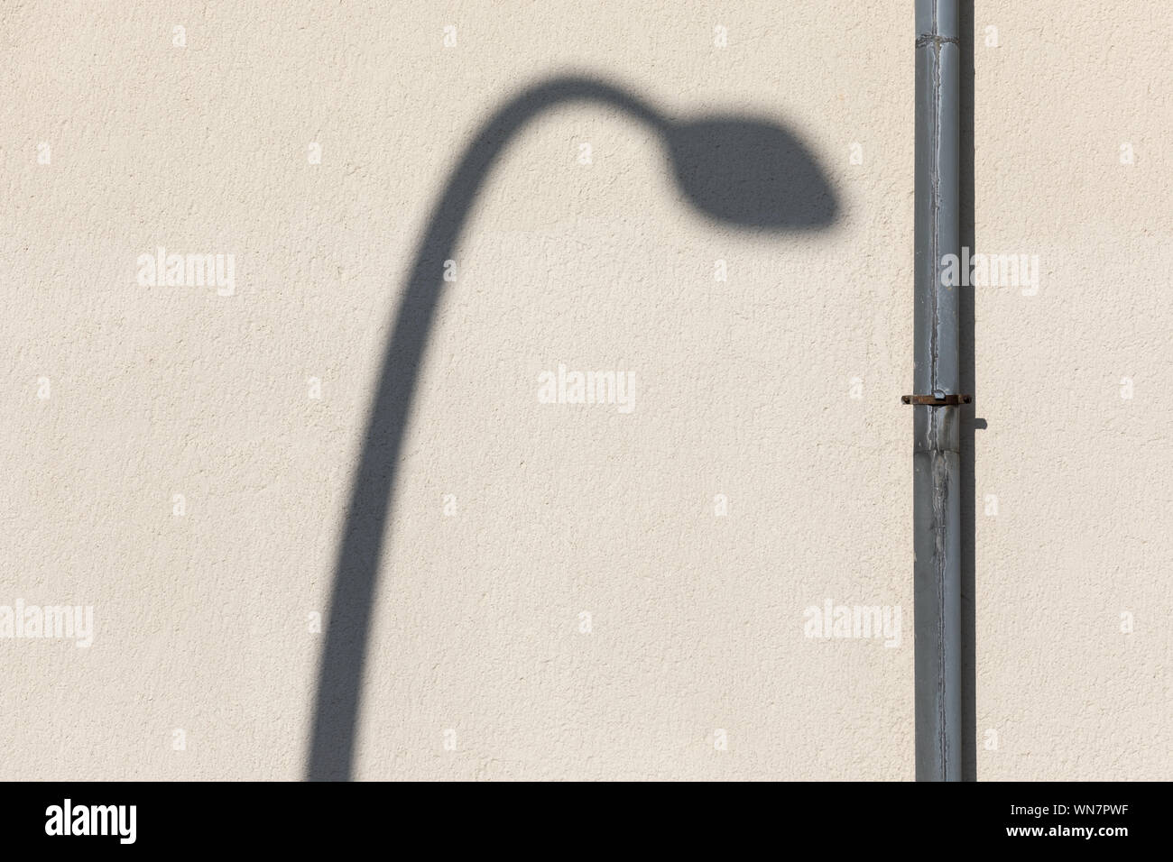 Street Light Shadow By Pipe On Wall Stock Photo