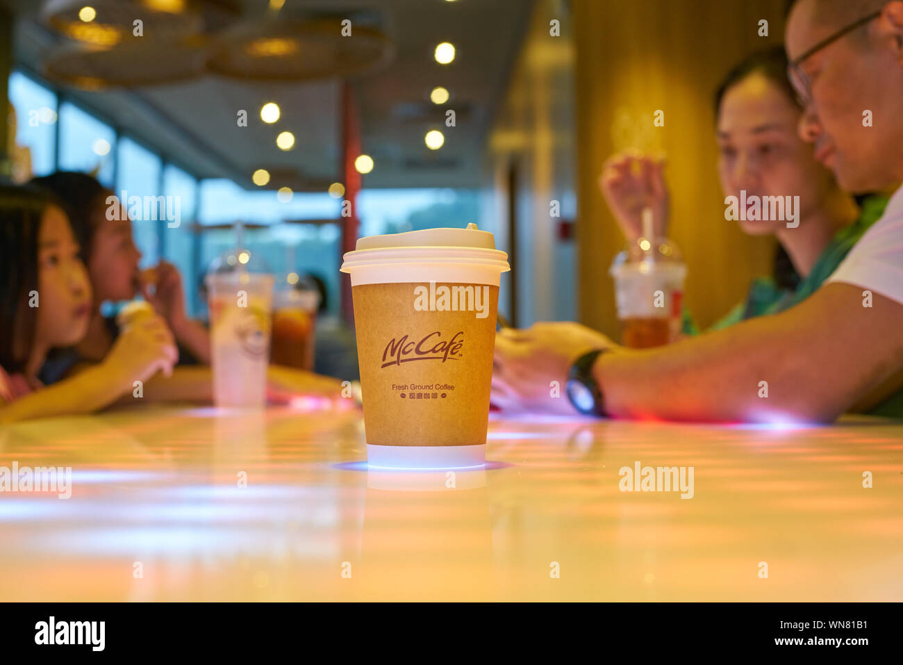 SHENZHEN, CHINA - CIRCA FEBRUARY, 2019: McCafe paper cup on a table at ...