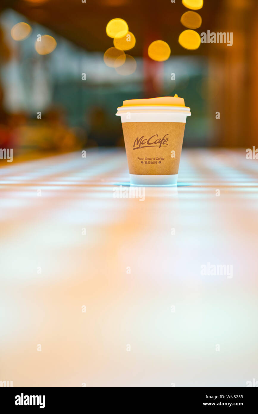 SHENZHEN, CHINA - CIRCA FEBRUARY, 2019: McCafe paper cup on a table at ...