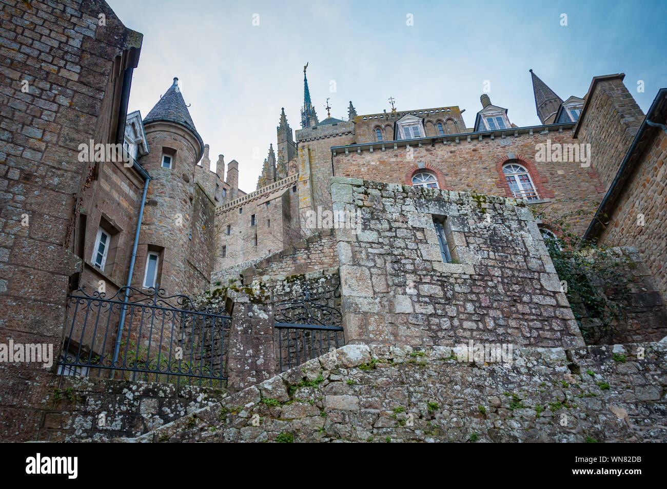 Stone walls of the labyrinth of the streets of the medieval castle of Mont Saint-Michel Stock Photo