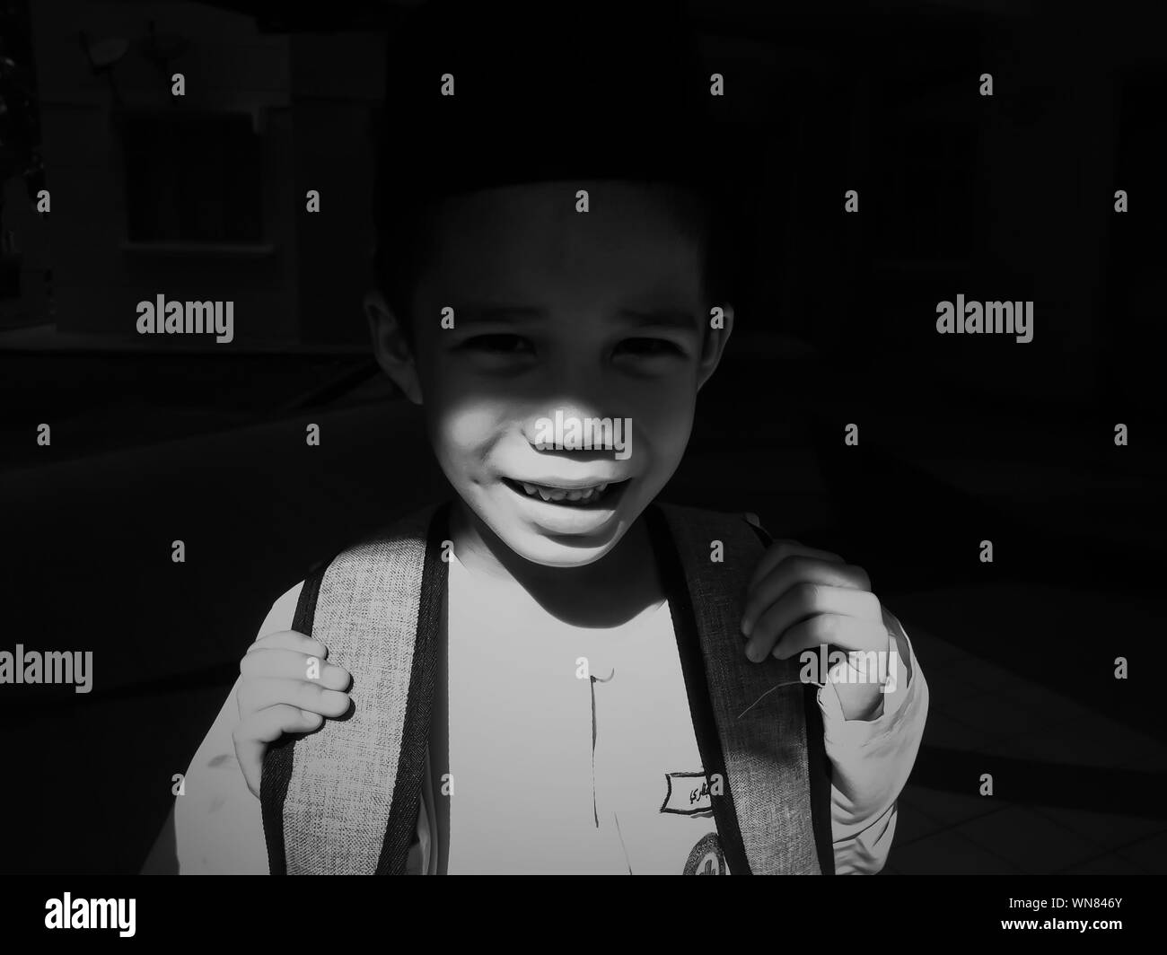 Portrait Of Boy With Backpack Standing In Darkroom Stock Photo Alamy