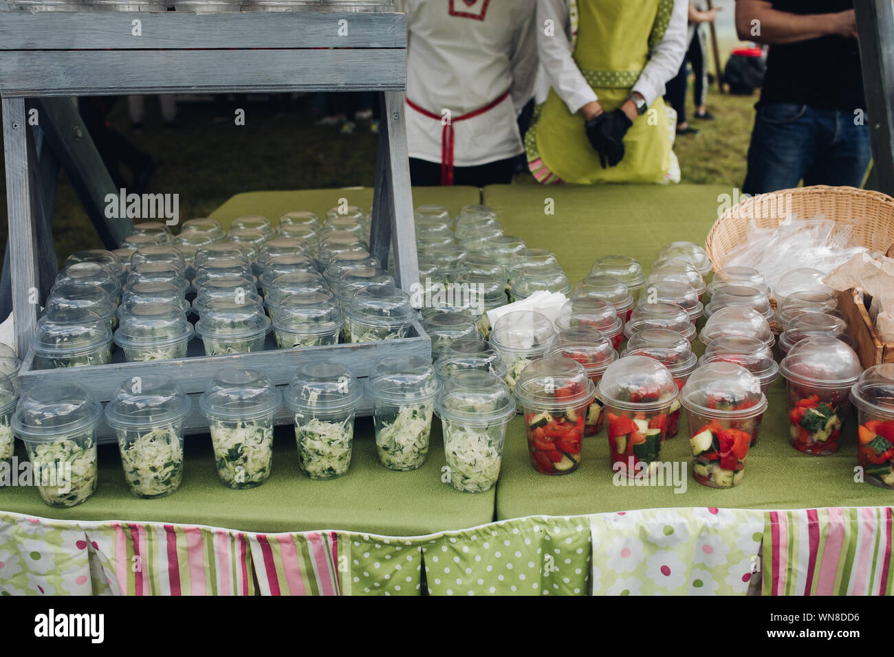 Organic veggies in cups to go.Closeup of loads of plastic cups filled