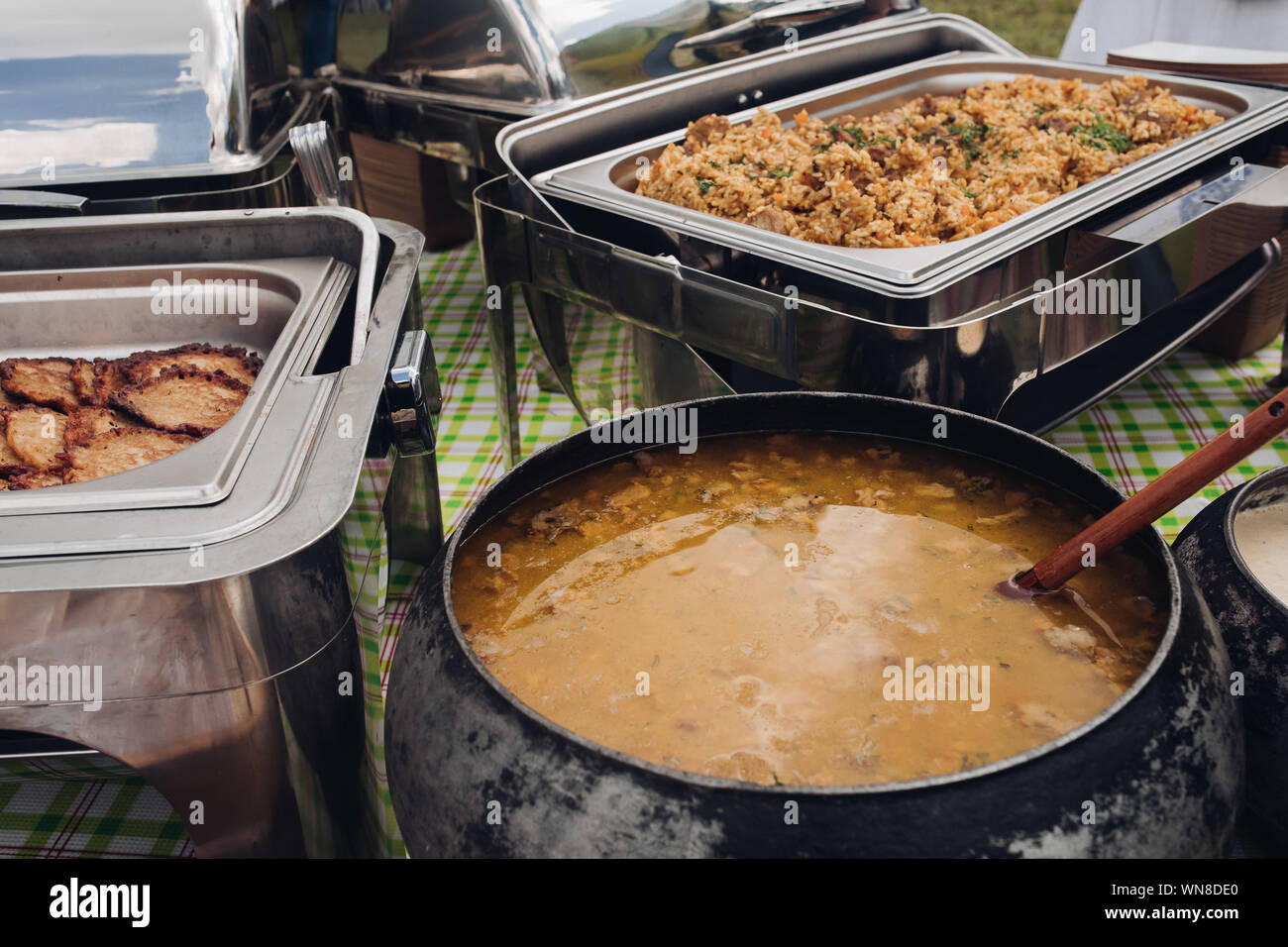 Closeup appetizing pilaf with gravy chicken beef serving for buffet