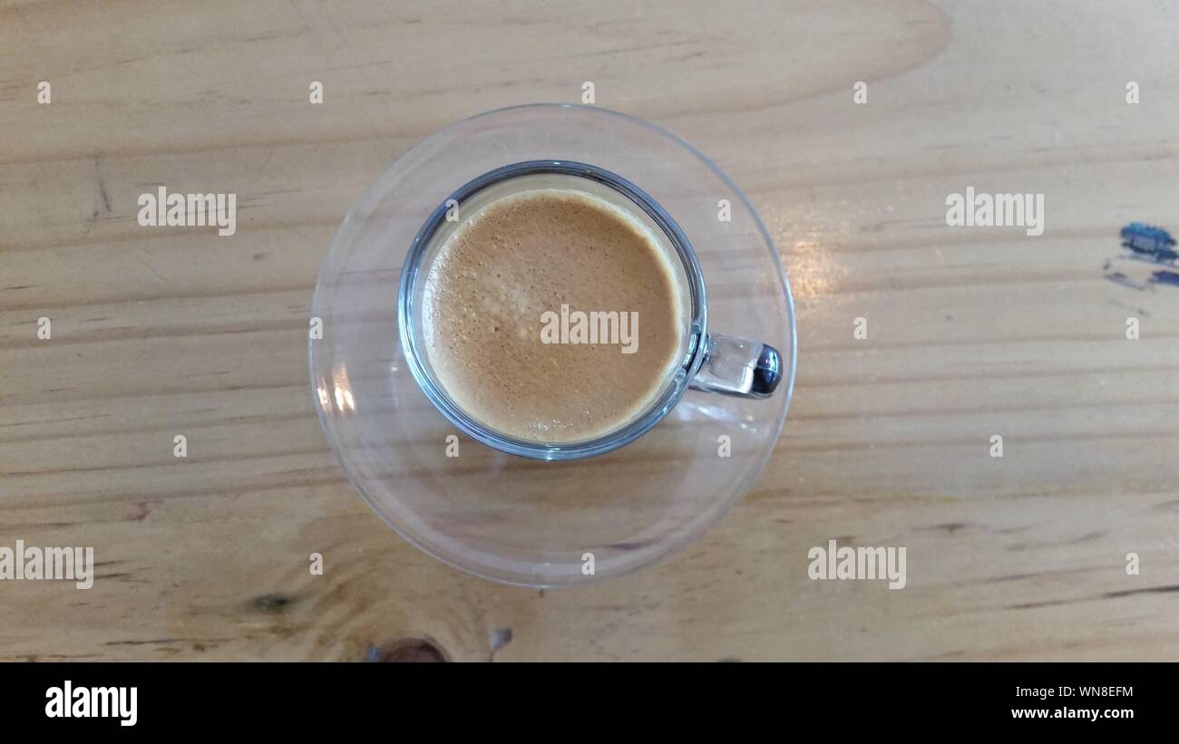 Directly Above Shot Of Coffee Cup On Wooden Table Stock Photo