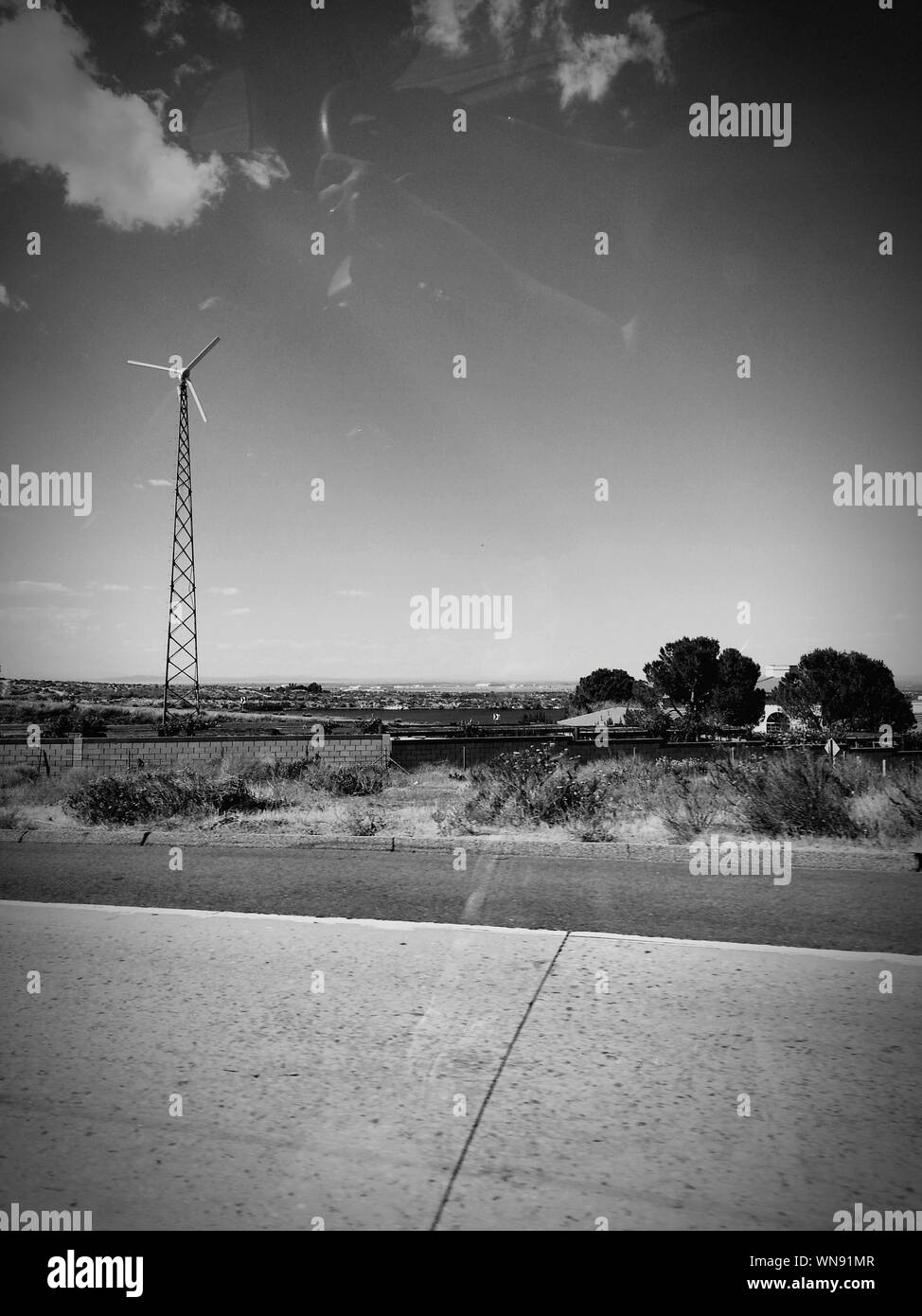 View Of Wind Turbine On Landscape Against Sky Stock Photo