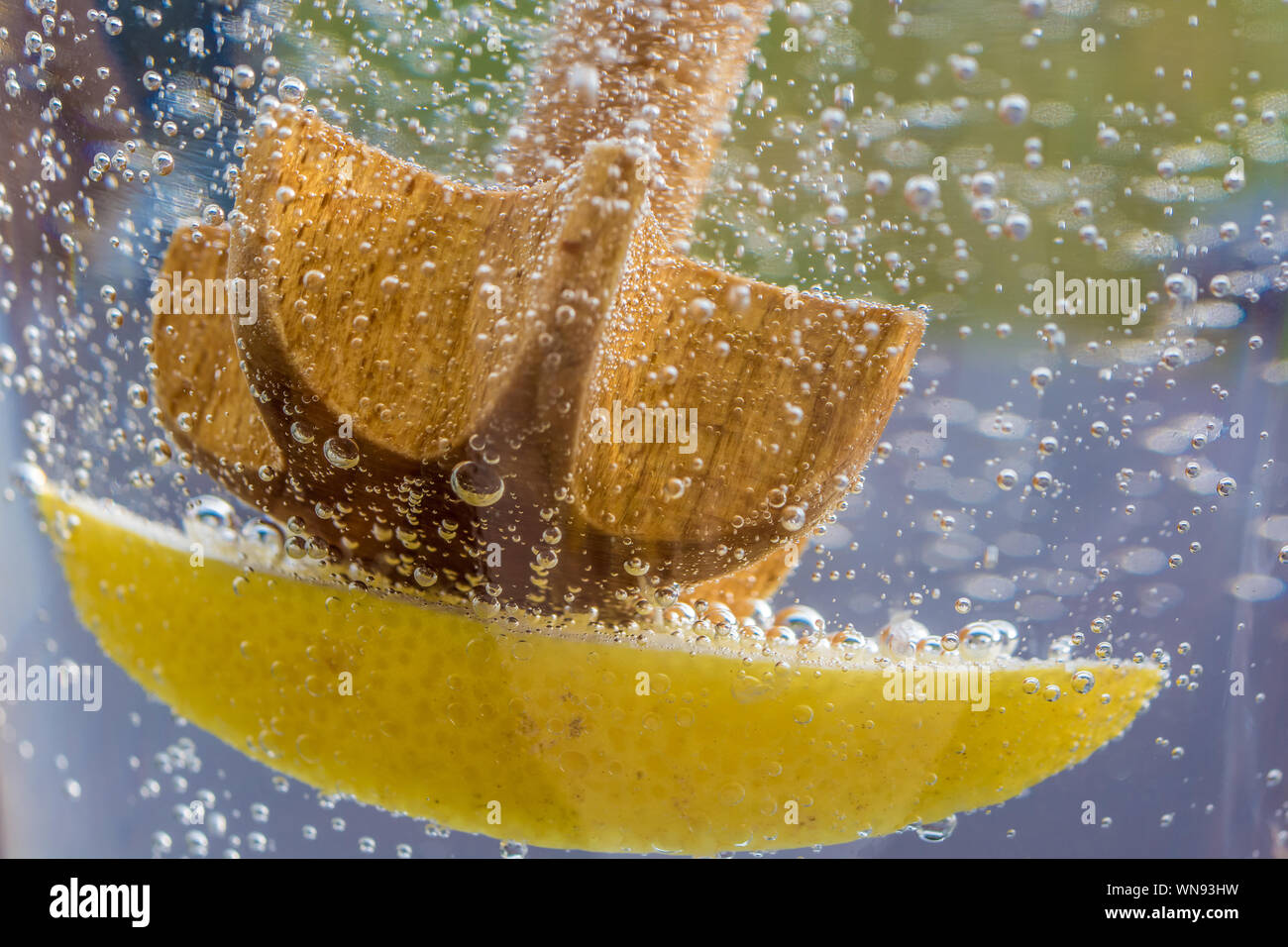 Bubbling water with lemon as a refreshment in summer Stock Photo