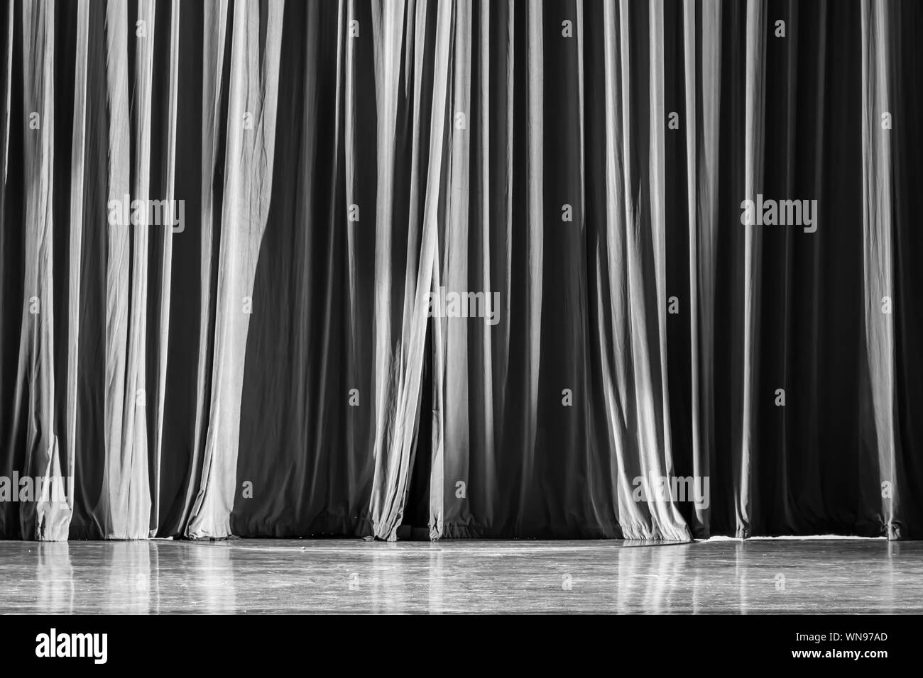 Black And White Curtains And Spotlight In The Theater Between
