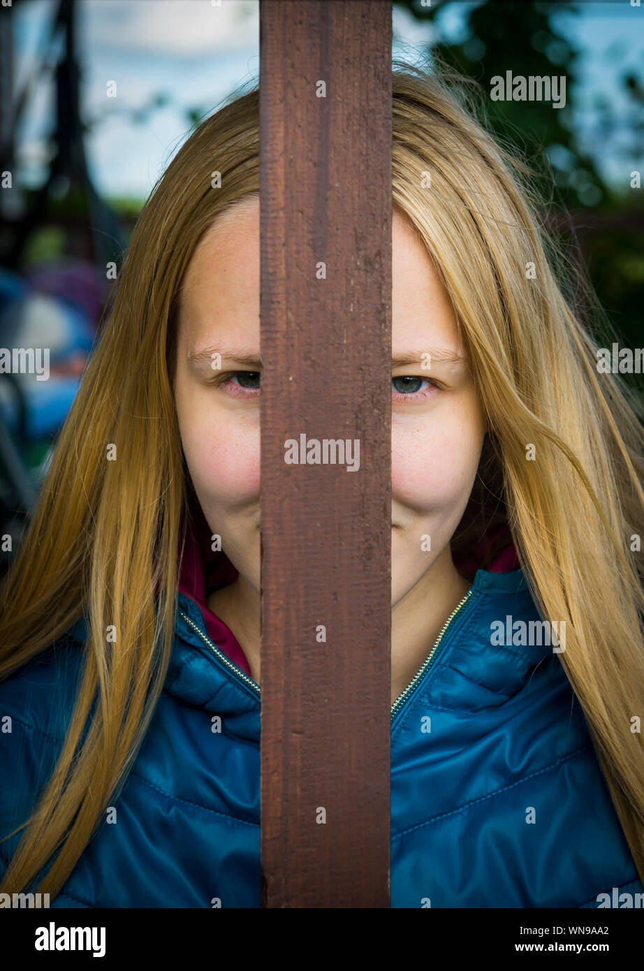Portrait Of Young Woman Face With Wooden Log Stock Photo